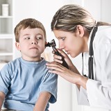Doctor examining boy