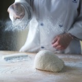 Baker prepping work suface